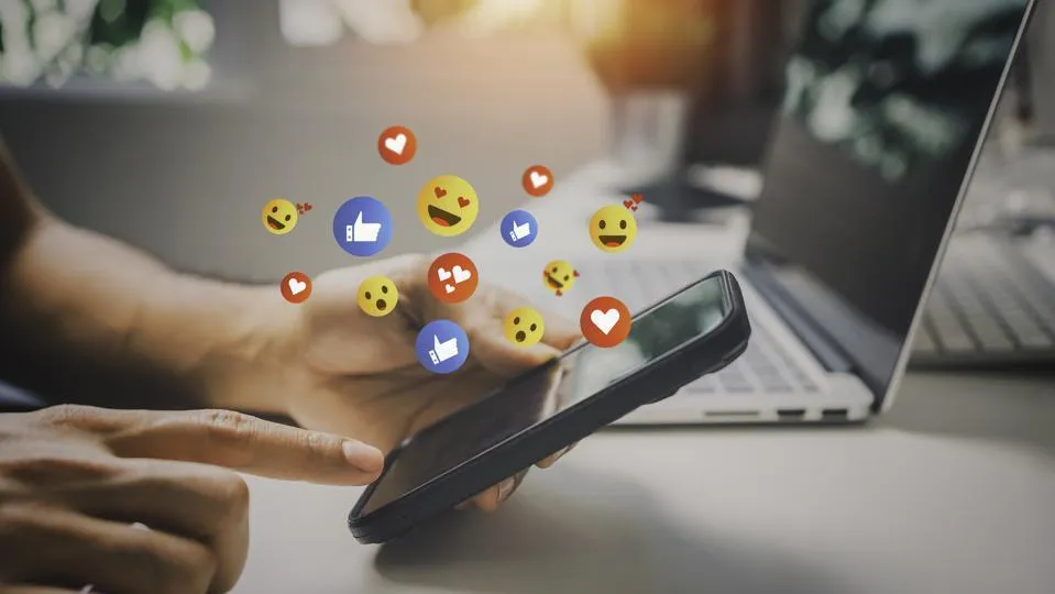 Social media engagement on phone and laptop